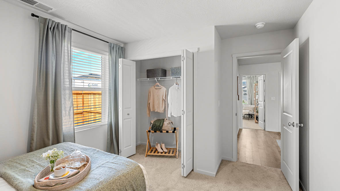 Addysen Park bedroom with carpet, bedroom with pillows, dresser, circle mirror, windows, nightstand with lamp, and closet