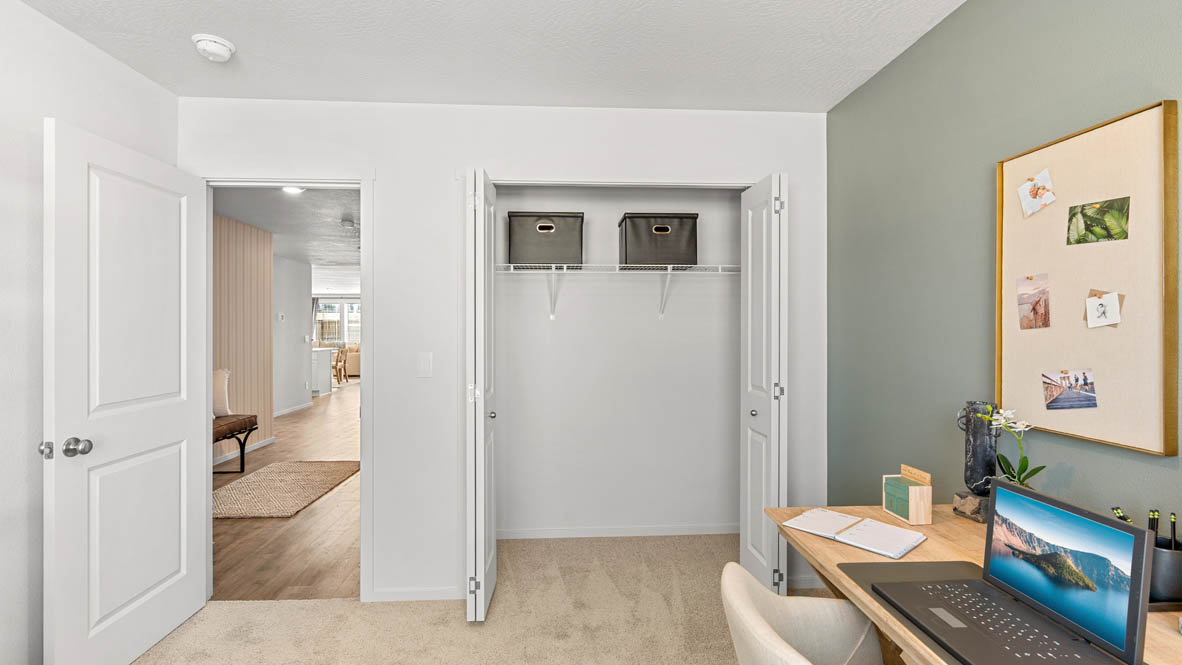 Addysen Park bedroom with carpet, bedroom with pillows, dresser, circle mirror, windows, nightstand with lamp, and closet