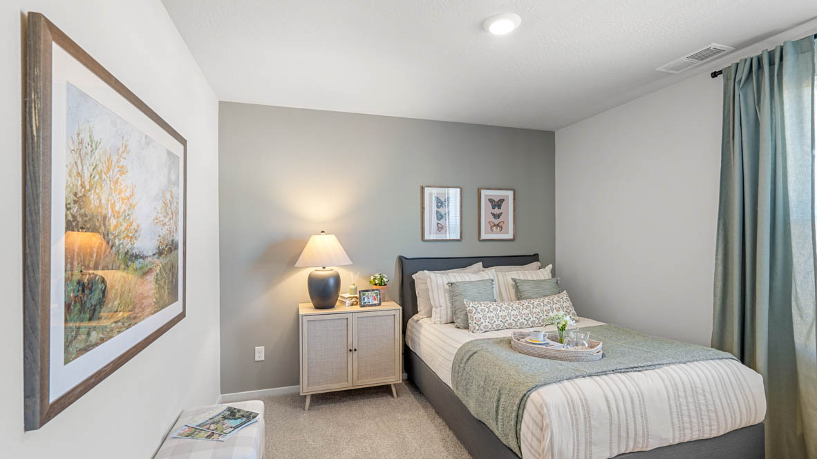 Addysen Park bedroom with carpet, bedroom with pillows, dresser, circle mirror, windows, nightstand with lamp