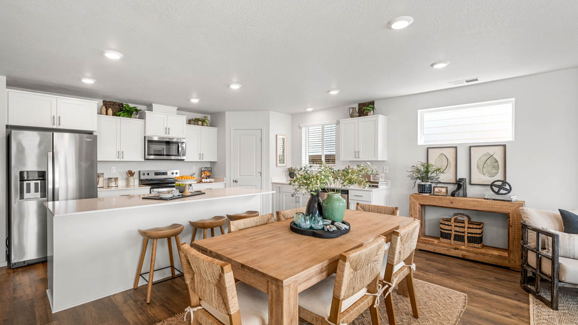 Addysen Park dining room with table and four chairs, the kitchen and great room in the background