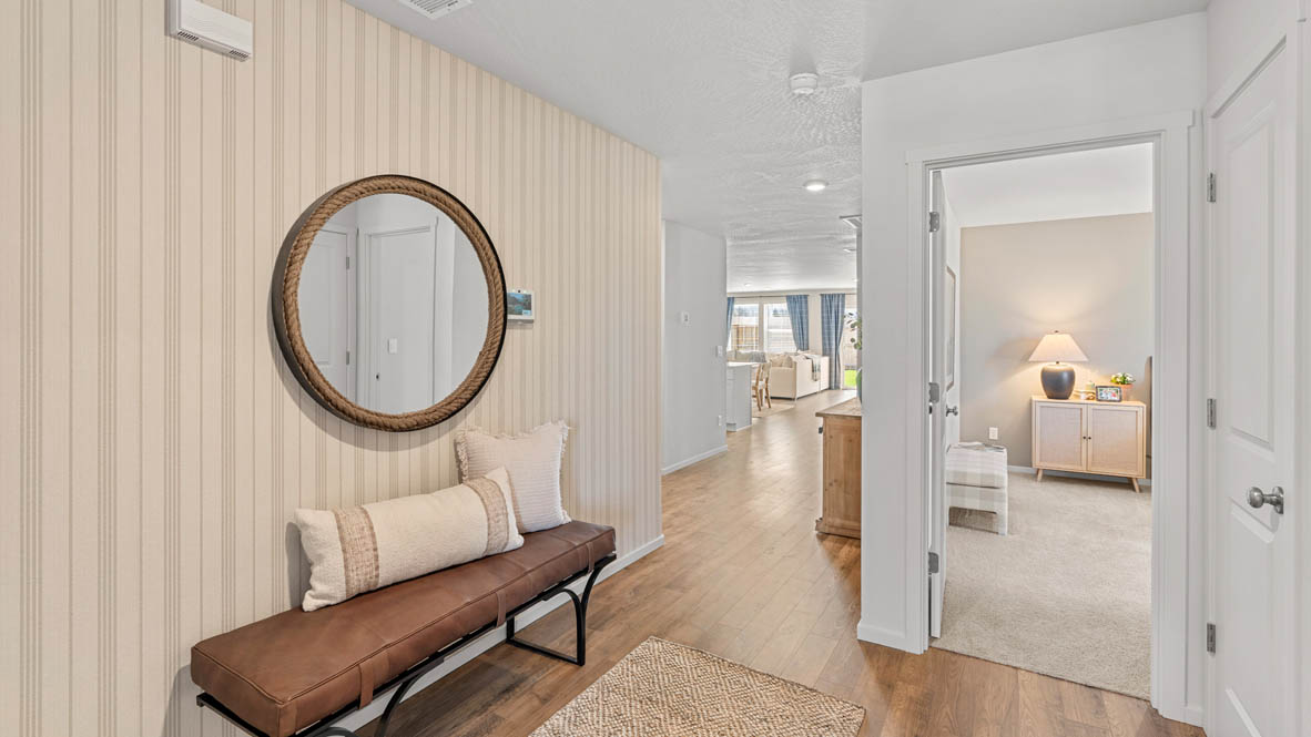 Addysen Park entry with an entry table and circle mirror, laminate flooring, white walls