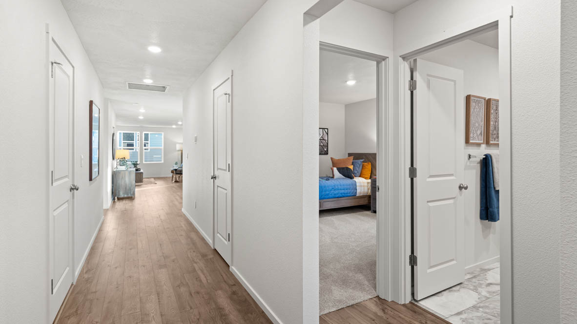 Addysen Park entry with an entry with laminate flooring, white walls, and the hallway to the open concept living space