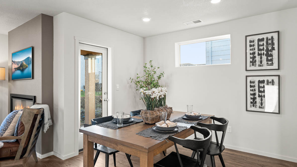 Addysen Park dining room with table and four chairs, the kitchen and great room in the background