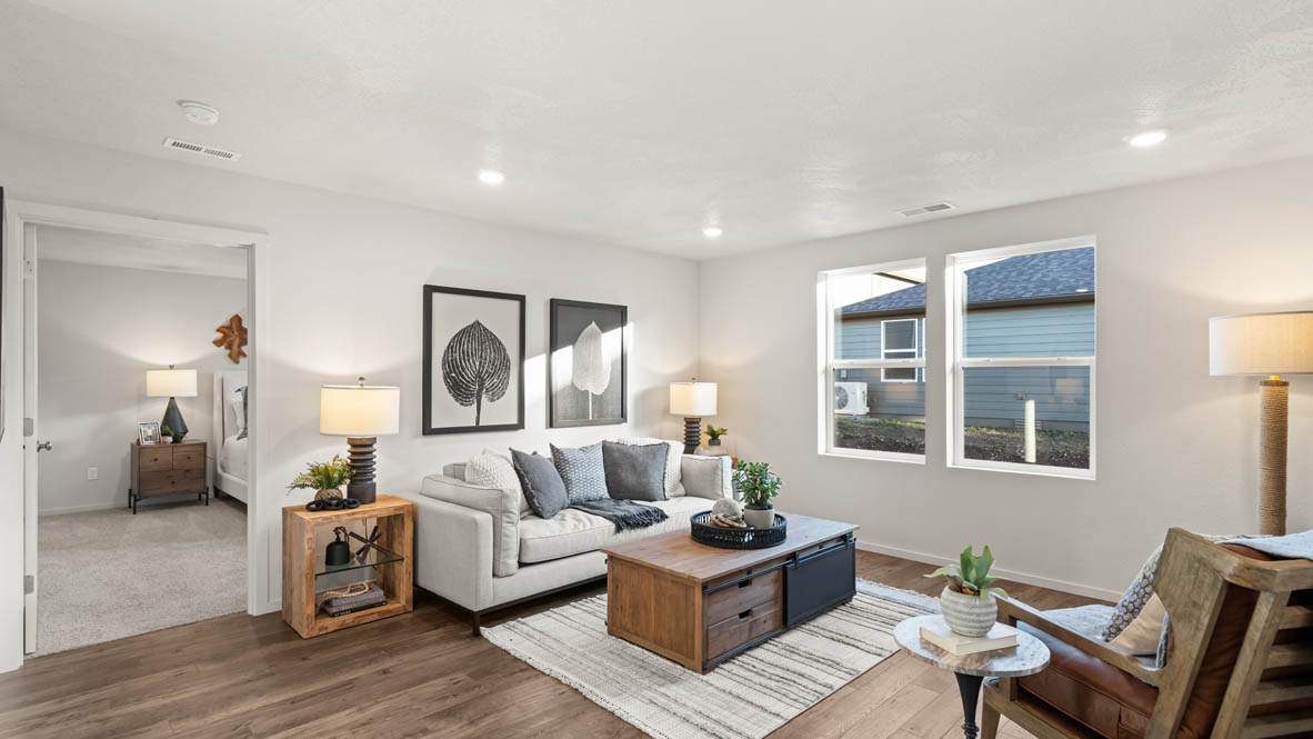 Addysen Park great room with an electric fireplace, couches, coffee table, windows, blinds, and flooring