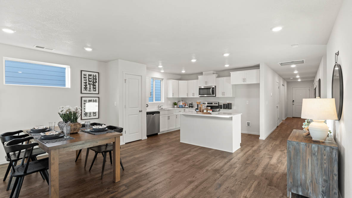 Addysen Park dining room with table and four chairs, the kitchen and kitchen in the background