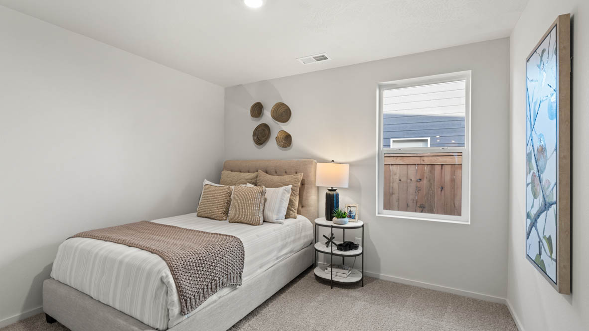 Addysen Park bedroom with carpet, bedroom with pillows, dresser, circle mirror, windows, nightstand with lamp