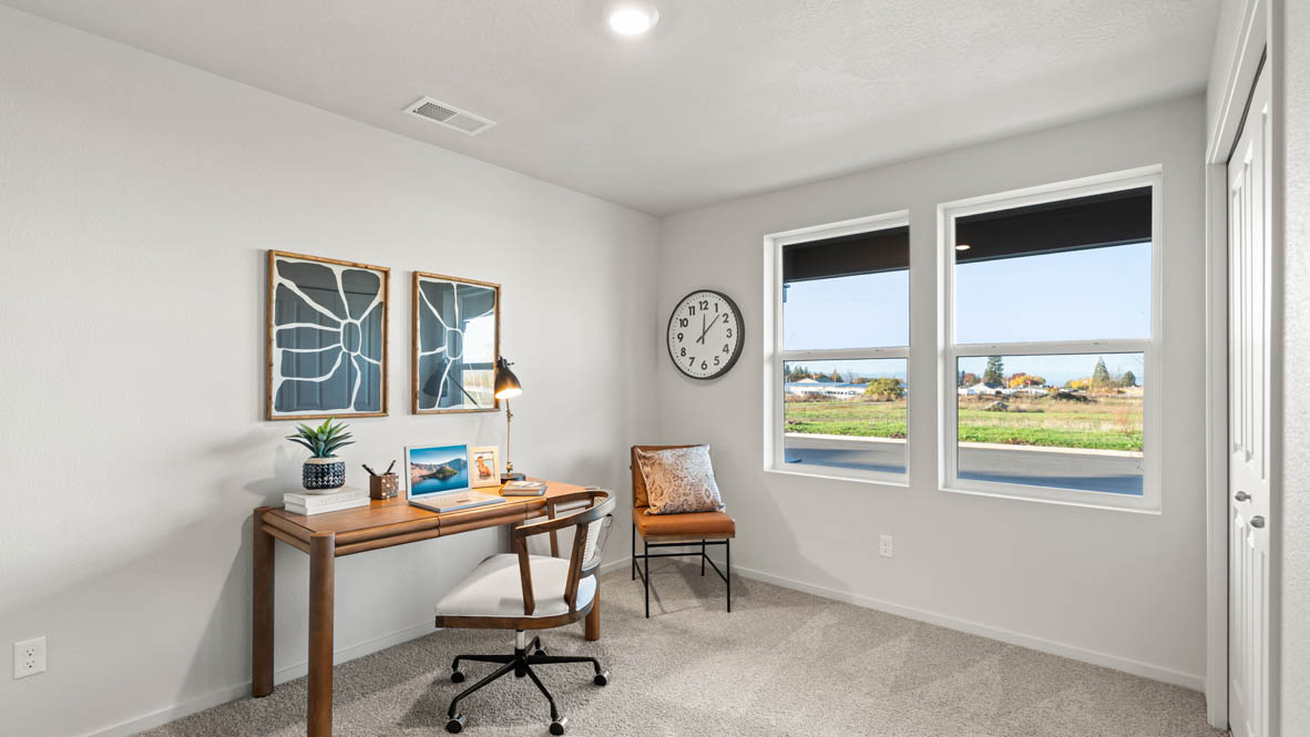 Addysen Park bedroom with carpet, bedroom with pillows, dresser, circle mirror, windows, nightstand with lamp