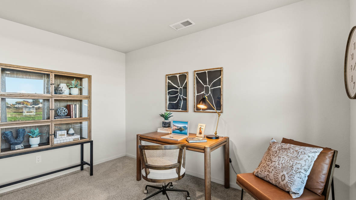 Addysen Park bedroom with carpet, desk with a chair, dresser, circle mirror, windows, nightstand with lamp