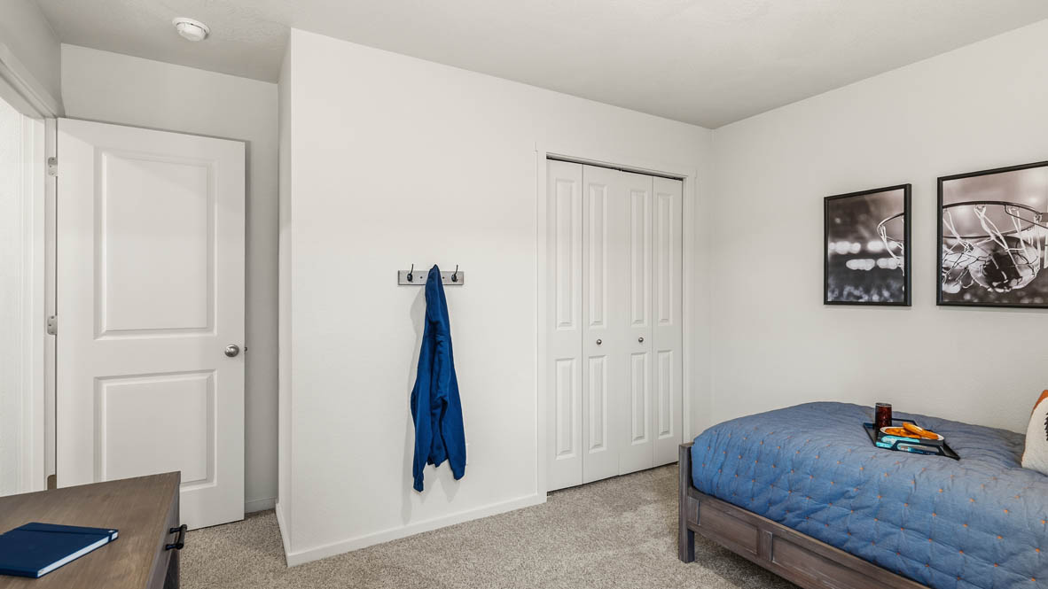 Addysen Park bedroom with carpet, bedroom with pillows, dresser, nightstand with lamp, and closet
