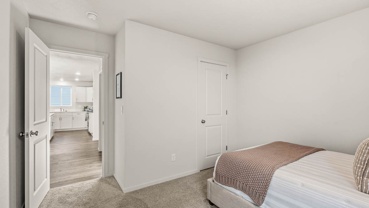 Addysen Park bedroom with carpet, bedroom with pillows, dresser, circle mirror, windows, nightstand with lamp