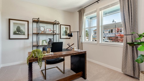 Avery Terrace Den set up as an office with a desk and decorative shelving