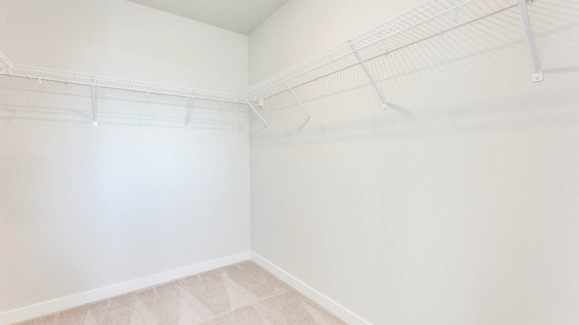 Avery Terrace walk in closet with white walls and white wire shelving