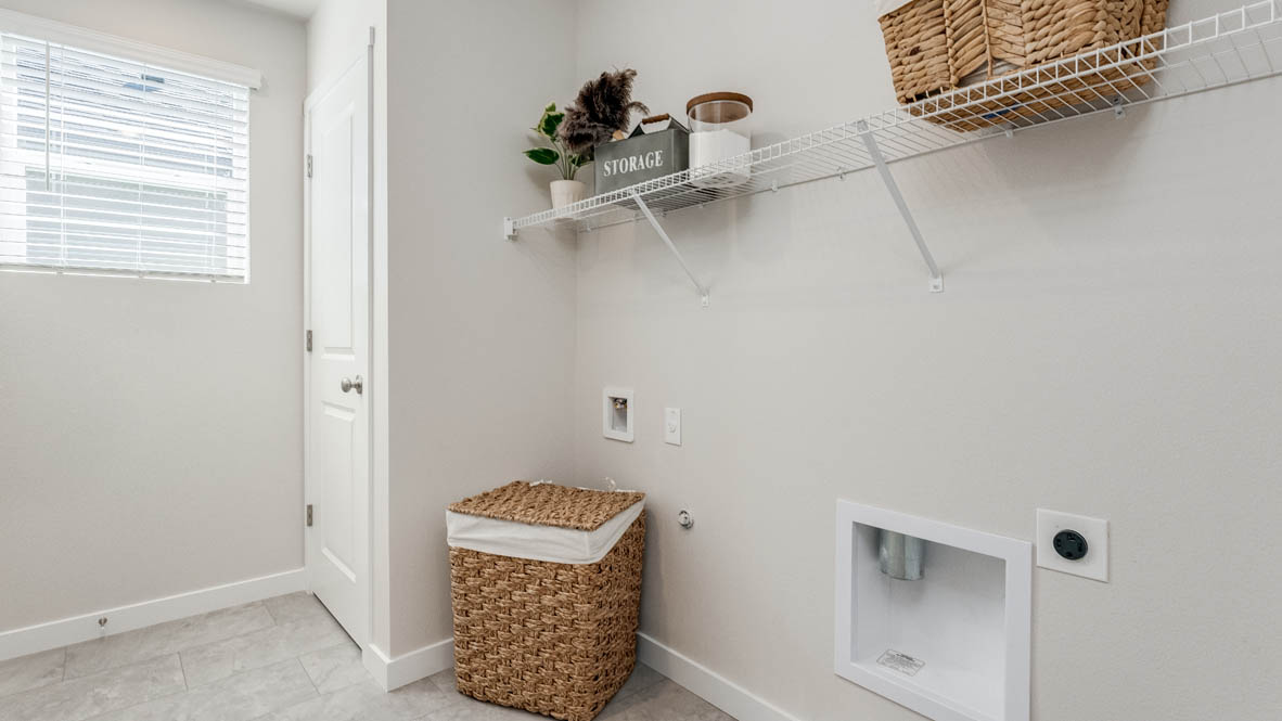 Avery Terrace Laundry Room with white wire shelving, a window