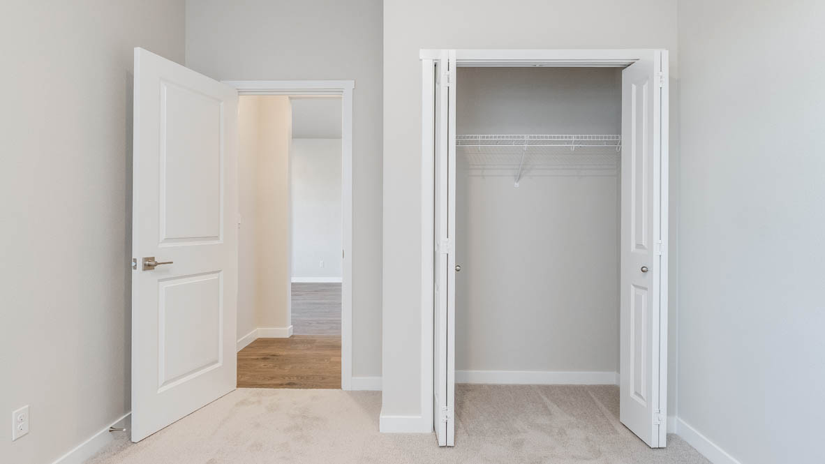 Avery Terrace bedroom with carpet, white walls, and a closet