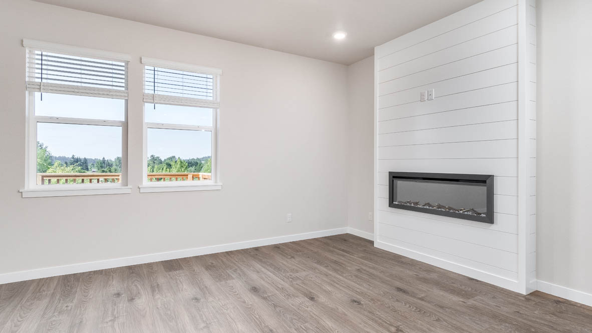 Avery Terrace Great Room with laminate flooring, white walls, electric fireplace, windows