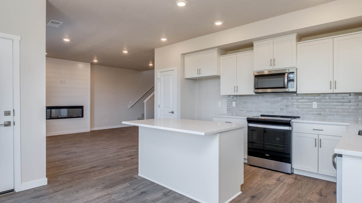 Avery Terrace dining room with laminate flooring, with the kitchen in the background