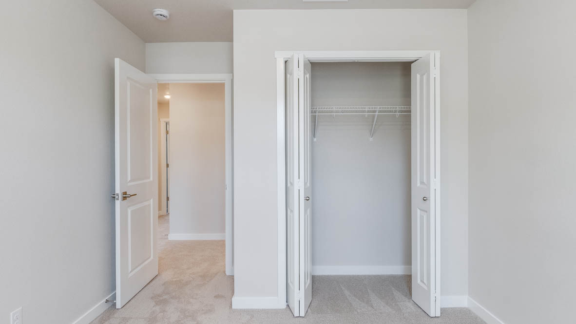 Avery Terrace bedroom with carpet, white walls, and a closet