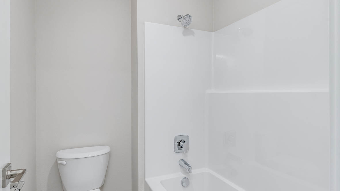 Avery Terrace bathroom with a white shower tub, and toilet