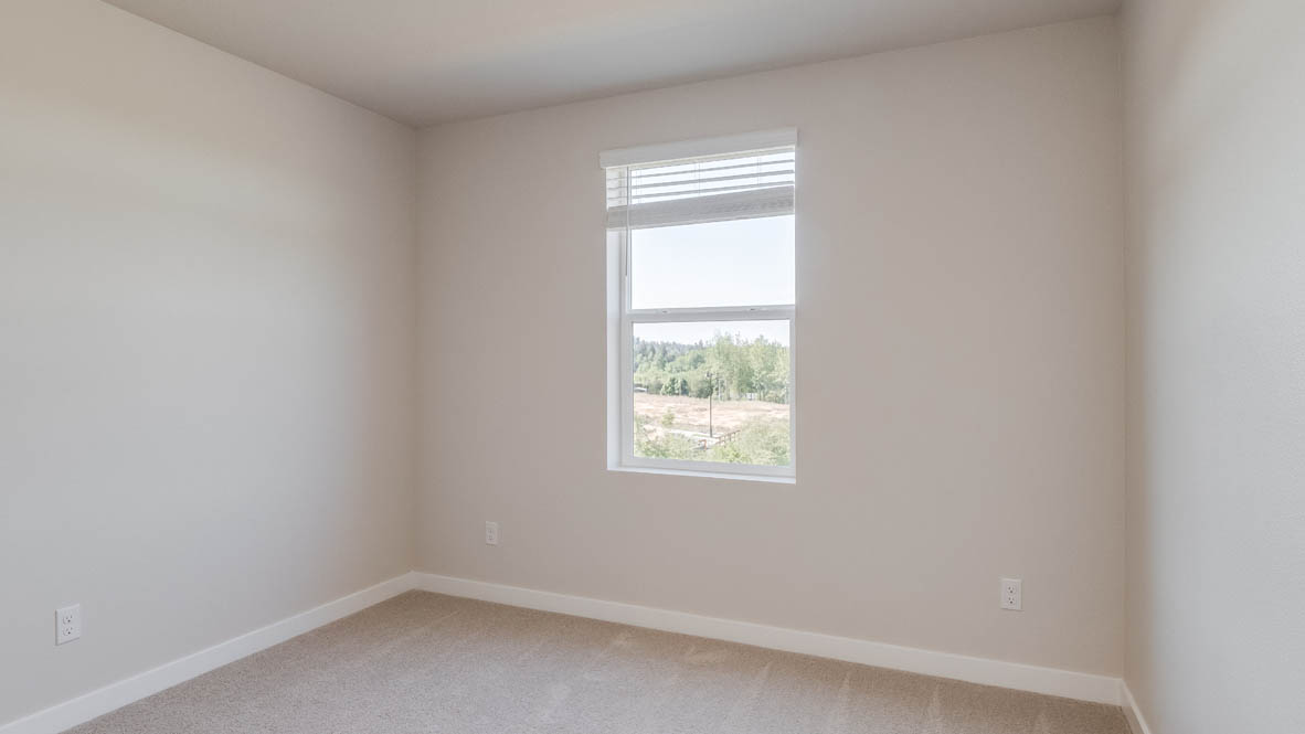 Avery Terrace Bedroom with carpet, white walls, and a window