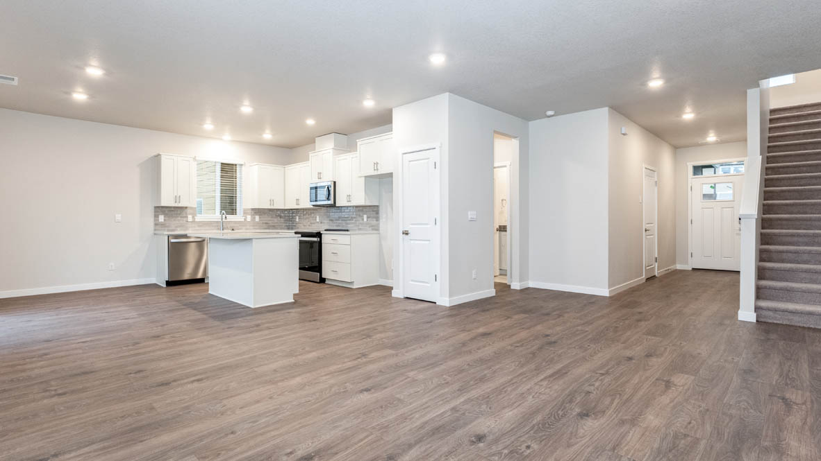 Avery terrace Kitchen with quartz countertops, island, stainless steel appliances, cabinets, and a window