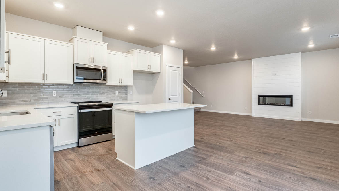 Avery terrace Kitchen with quartz countertops, island, stainless steel appliances, cabinets, and a window