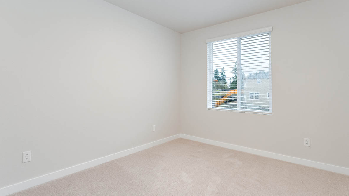 Avery Terrace bedroom with carpet, windows, and white walls