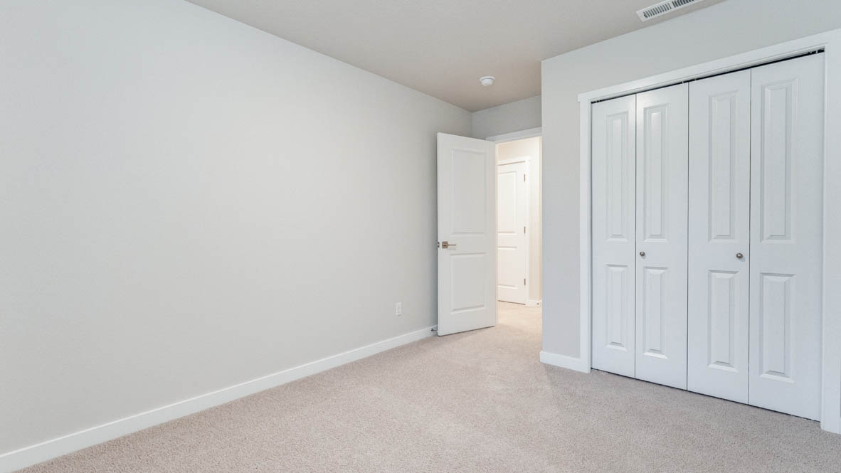 Avery Terrace bedroom with carpet, windows, and white walls