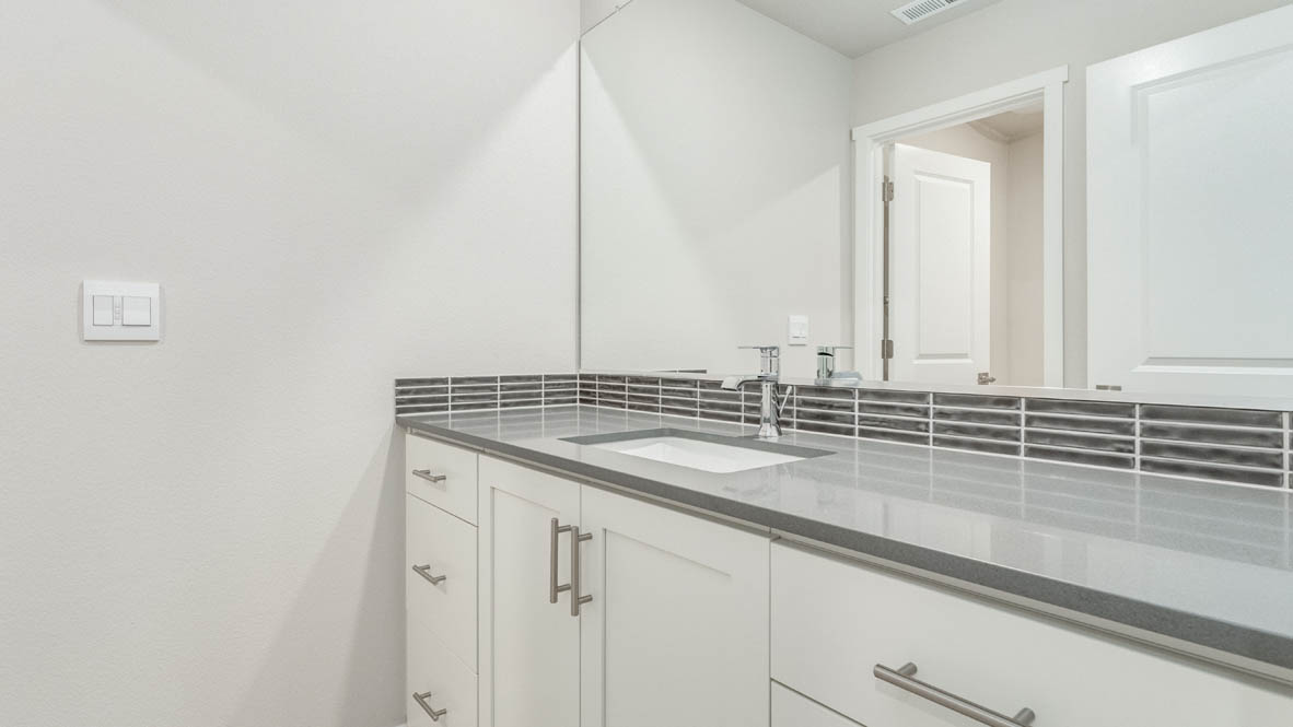 Avery Terrace bathroom with a double vanity sink and mirror, quartz countertops