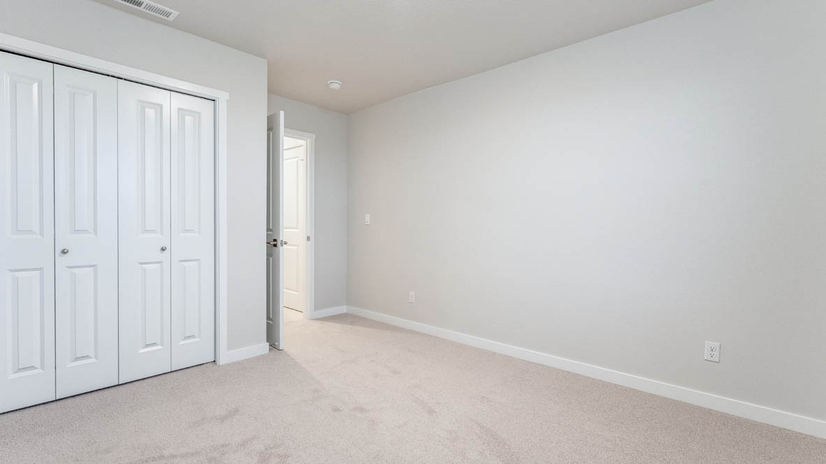 Avery Terrace bedroom with carpet, windows, and white walls