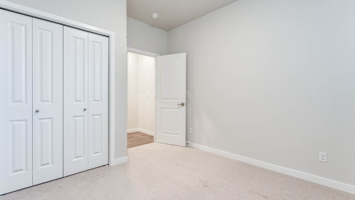 Avery Terrace bedroom with carpet, white walls, and a closet