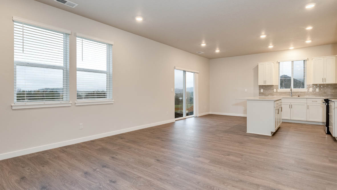 Avery terrace Kitchen with quartz countertops, island, stainless steel appliances, cabinets, and a window