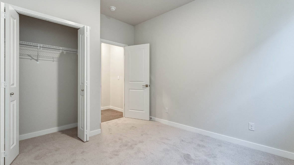 Avery Terrace bedroom with carpet, white walls, and a closet