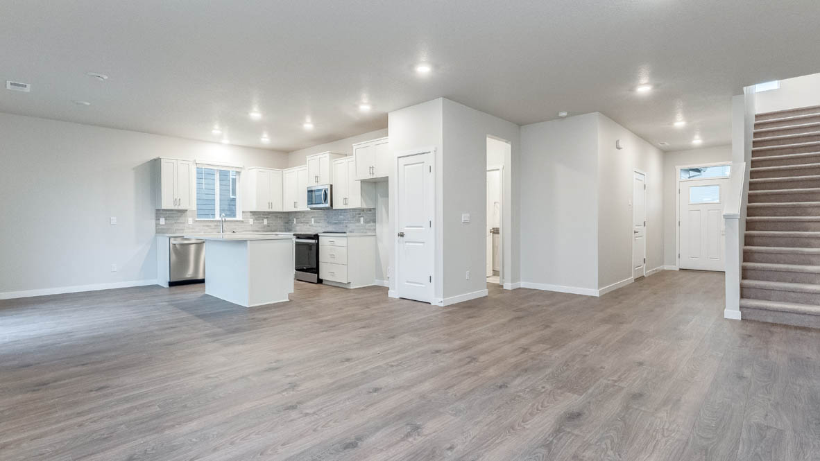 Avery terrace Kitchen with quartz countertops, island, stainless steel appliances, cabinets, and a window