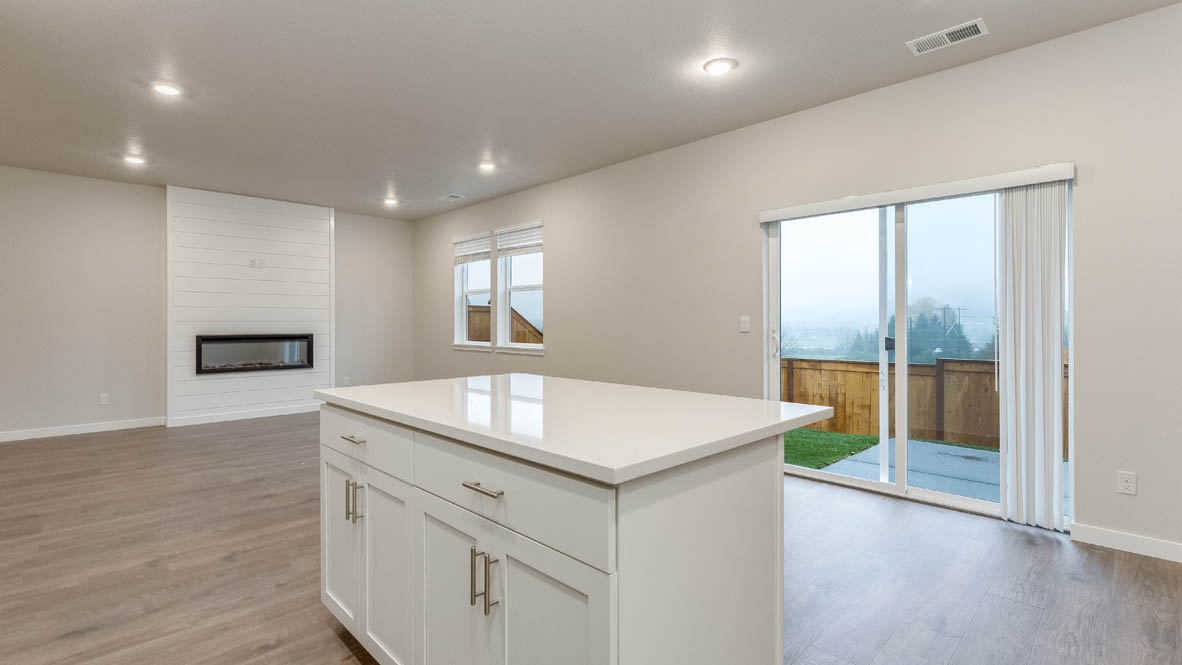 Avery terrace Kitchen with quartz countertops, island, stainless steel appliances, cabinets, and a window
