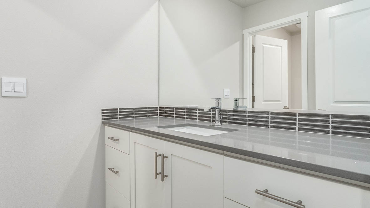 Avery Terrace bathroom with a double vanity sink and mirror, quartz countertops