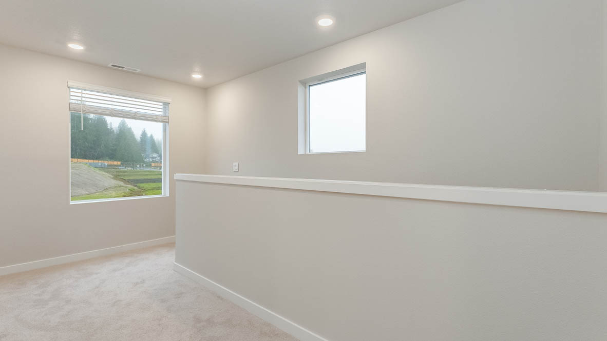 Avery Terrace upstairs hallway with carpet, windows, and bannister