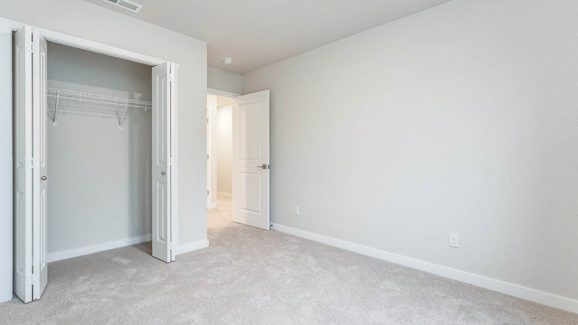 Avery Terrace bedroom with carpet, windows, and white walls