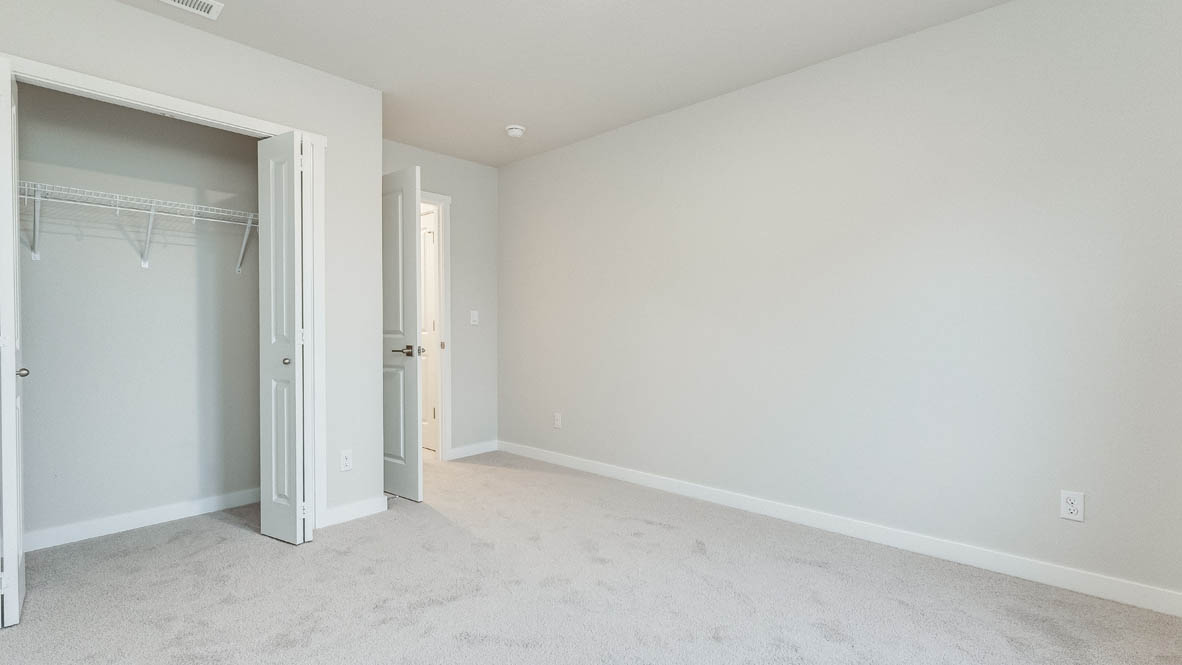 Avery Terrace bedroom with carpet, windows, and white walls