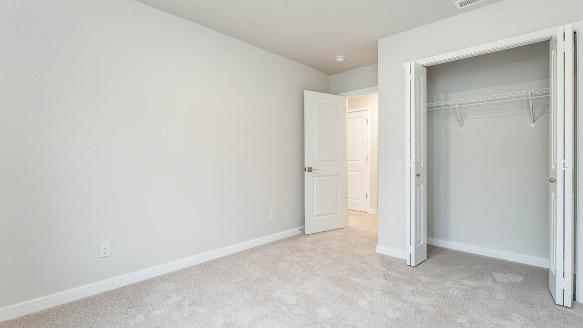 Avery Terrace bedroom with carpet, windows, and white walls