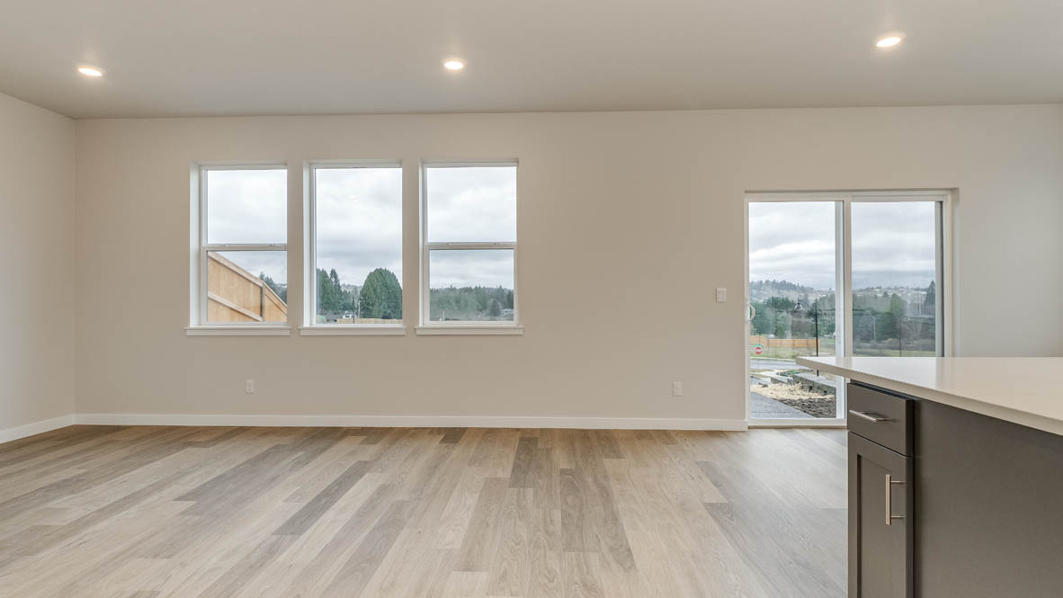 Avery Terrace great room with windows, white walls, and fireplace in the background