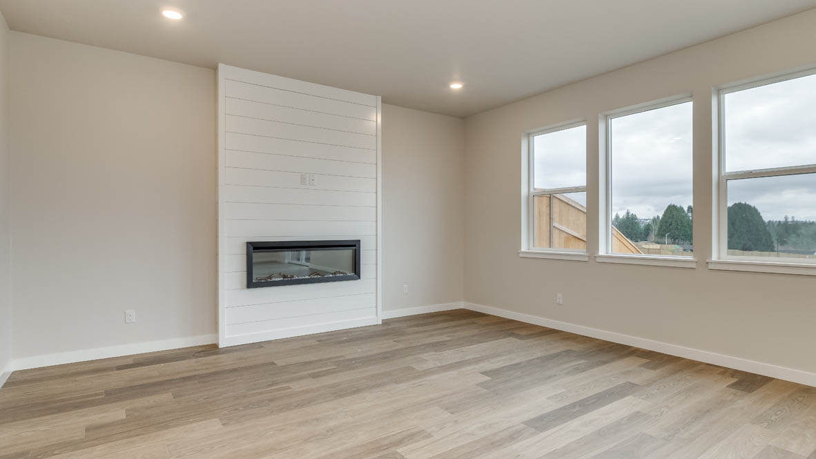 Avery Terrace great room with windows, white walls, and fireplace in the background