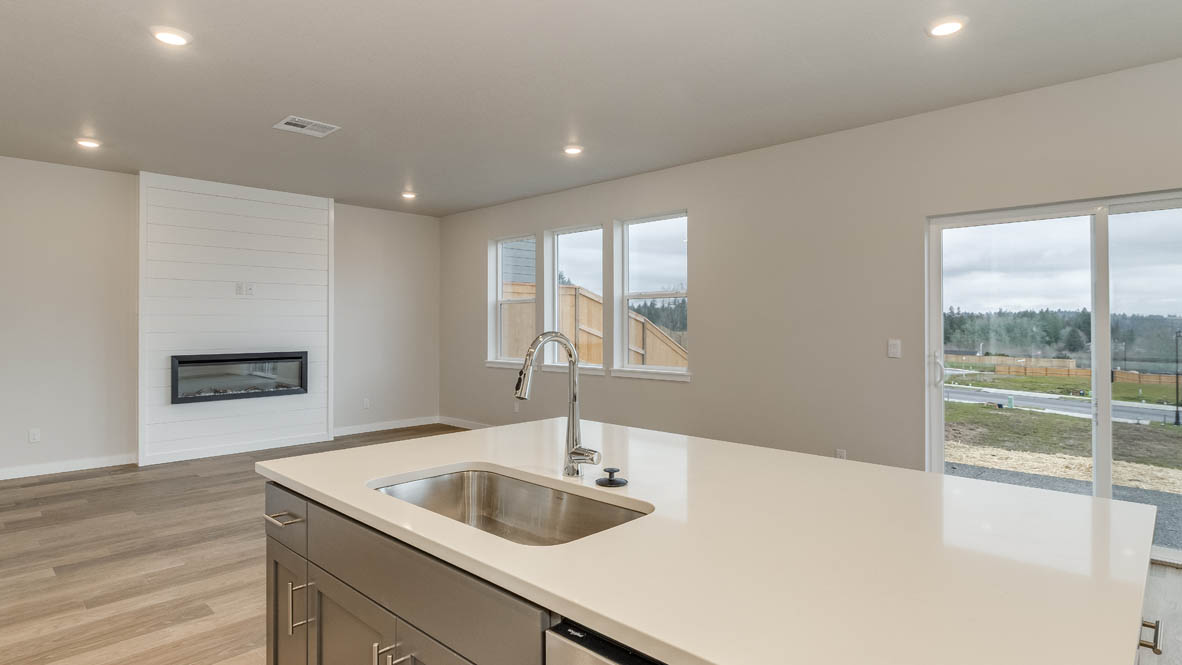 Avery terrace Kitchen with quartz countertops, island, stainless steel appliances, cabinets, and a window