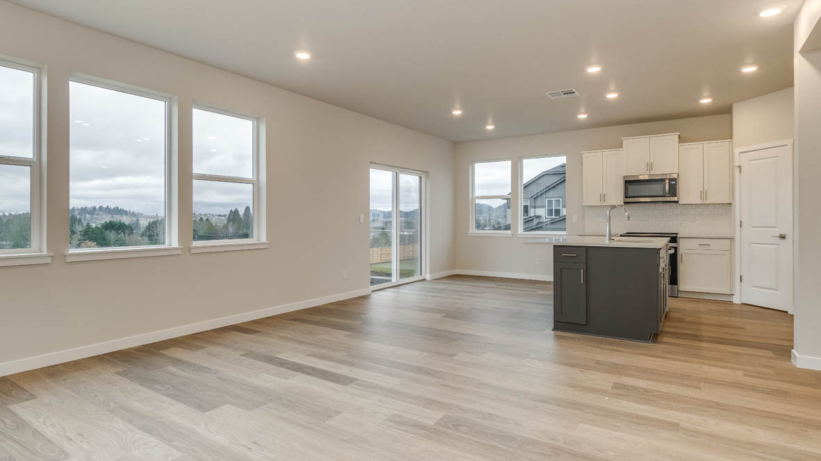 Avery terrace Kitchen with quartz countertops, island, stainless steel appliances, cabinets, and a window