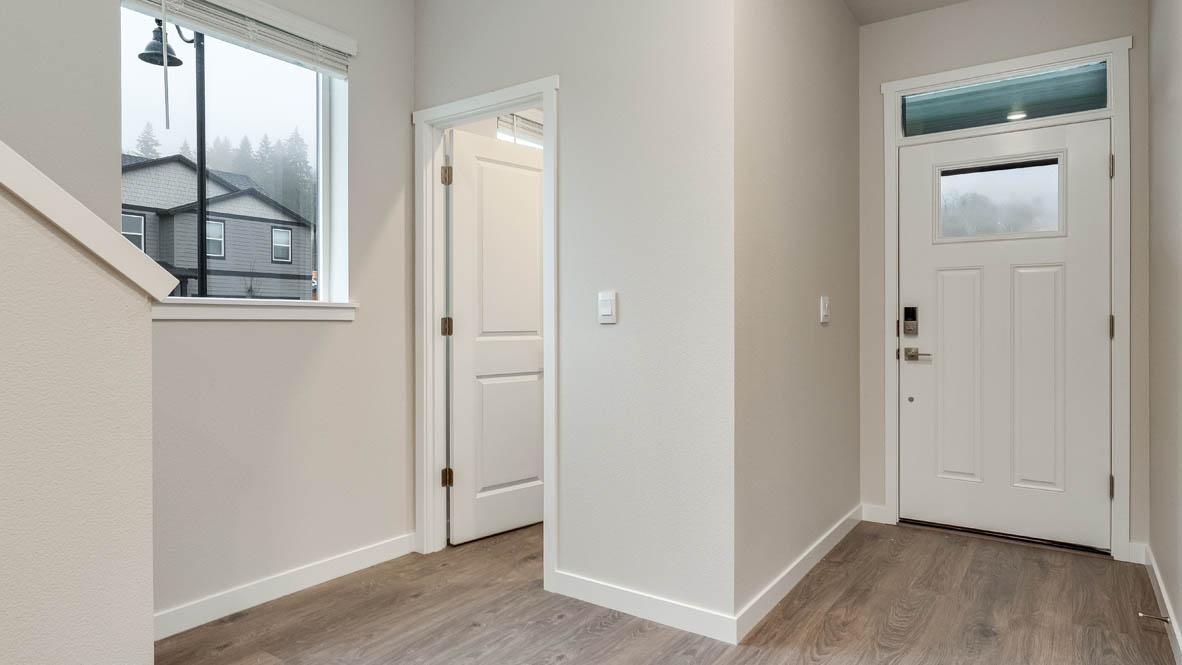 Entryway with a coat closet and laminate flooring