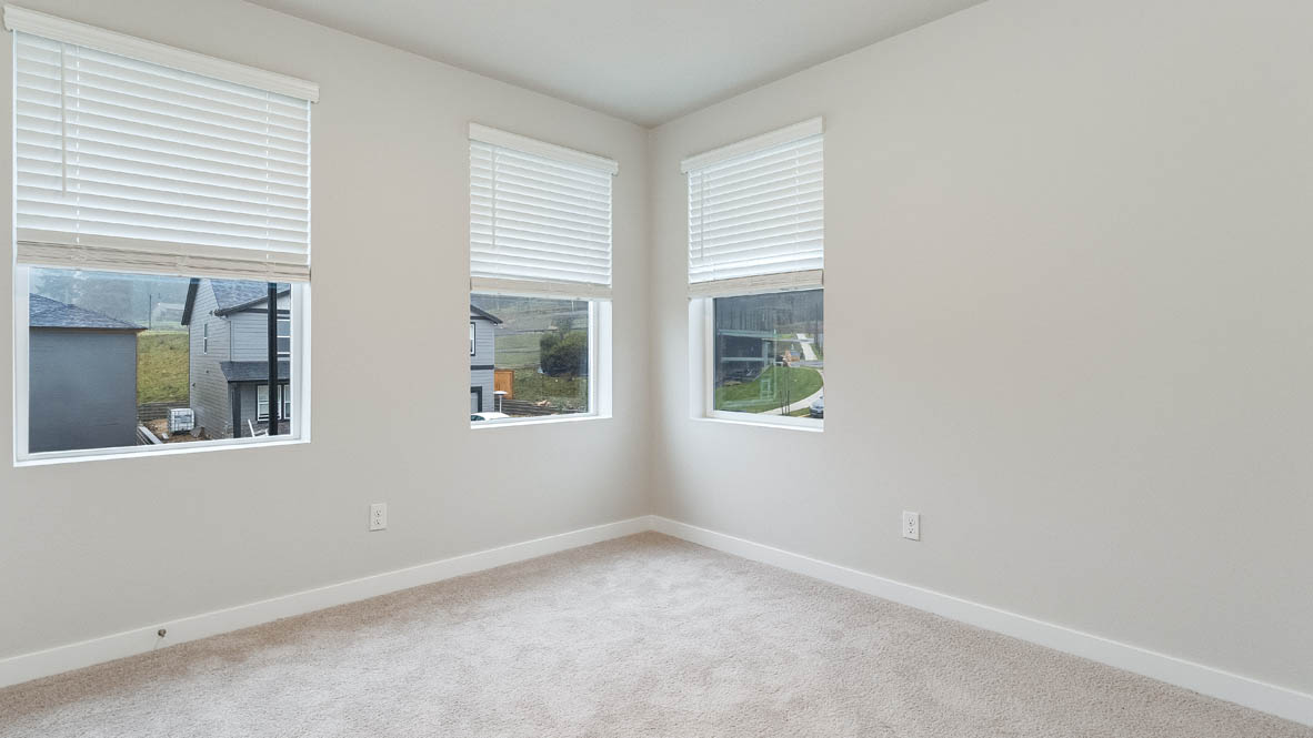 Bedroom with wall-to-wall carpet and a closet