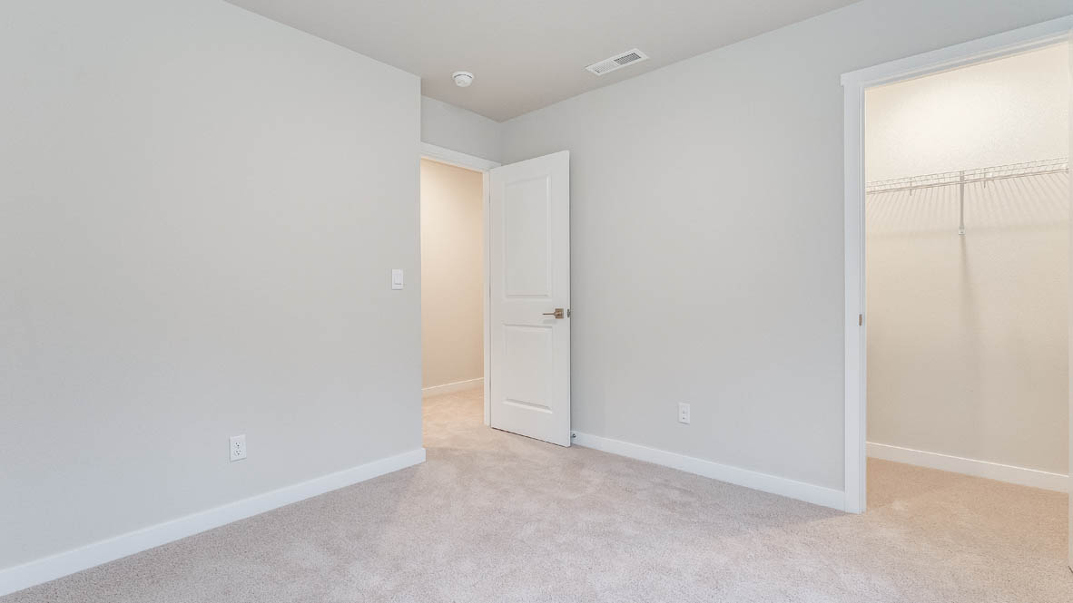 Bedroom with wall-to-wall carpet and a closet