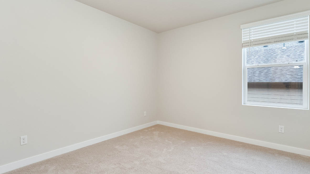 Bedroom with wall-to-wall carpet and a closet