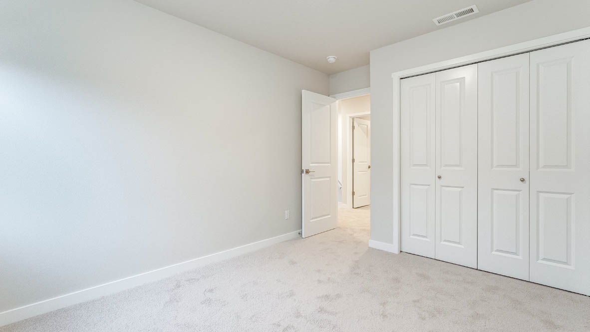 Bedroom with wall-to-wall carpet and a closet