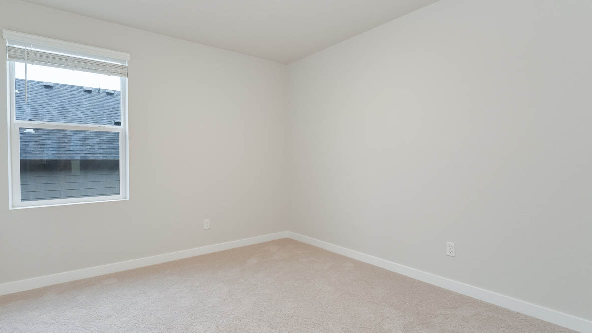 Bedroom with wall-to-wall carpet and a closet