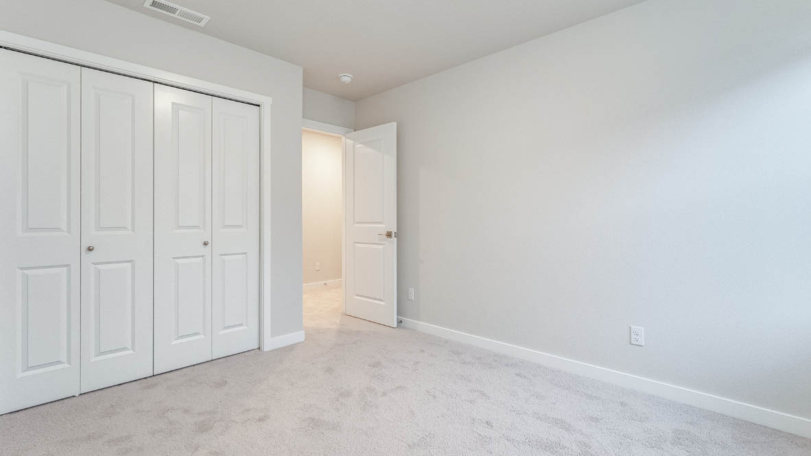 Bedroom with wall-to-wall carpet and a closet